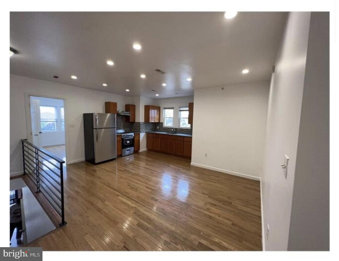 a view of kitchen with furniture and wooden floor