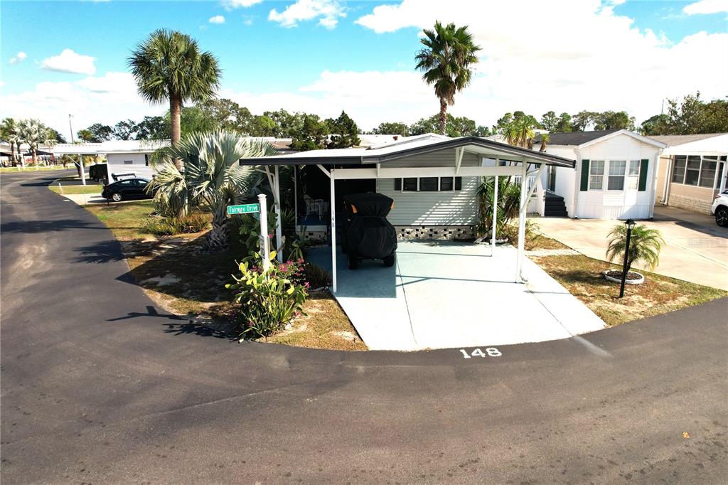 a front view of a house with a yard and potted plants