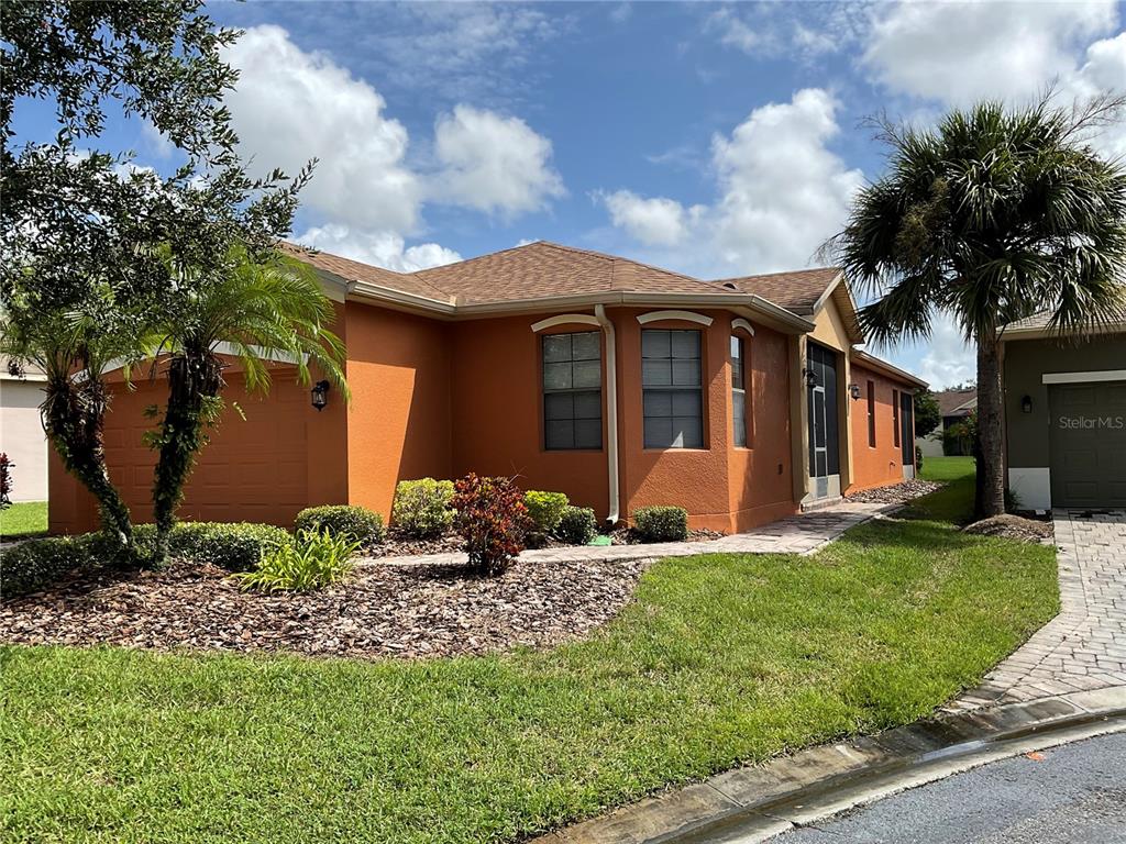 a front view of brick house with a yard