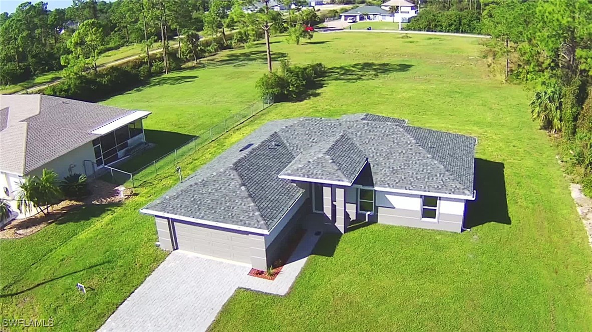 an aerial view of a house with a yard basket ball court and outdoor seating