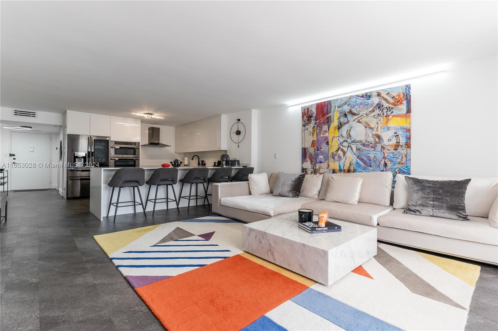 a living room with furniture and kitchen view