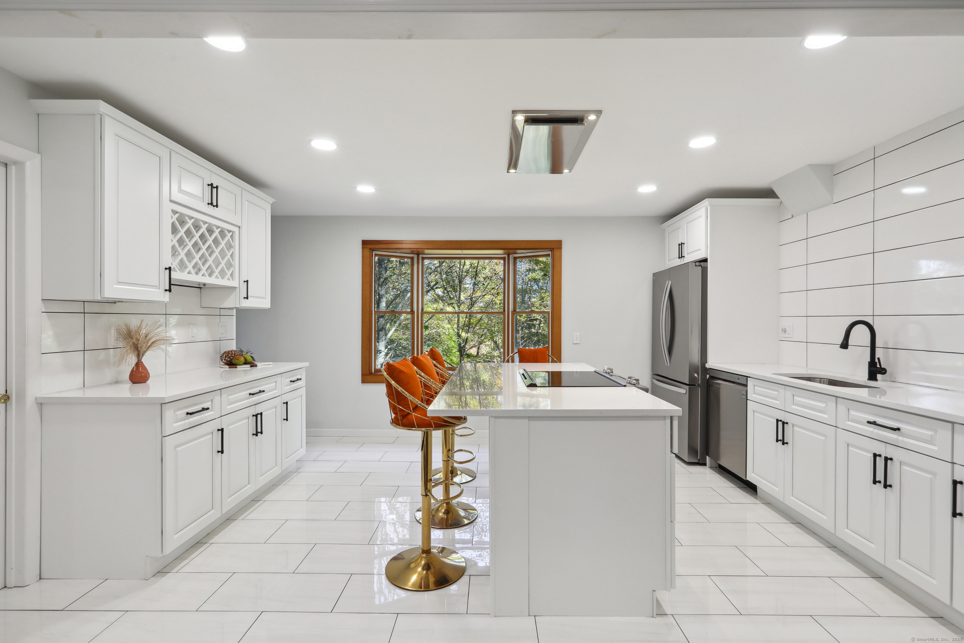 a kitchen with stainless steel appliances granite countertop a sink and cabinets