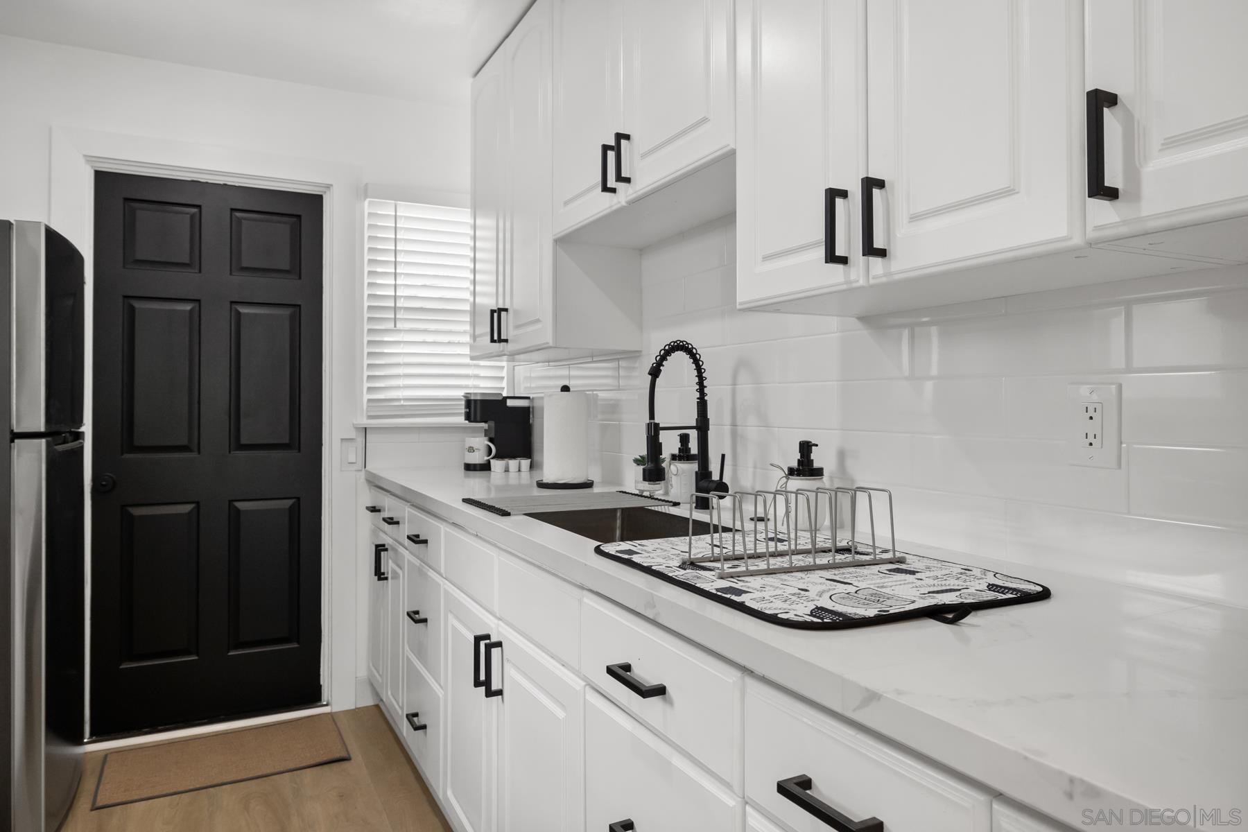 a kitchen with stainless steel appliances a sink and cabinets