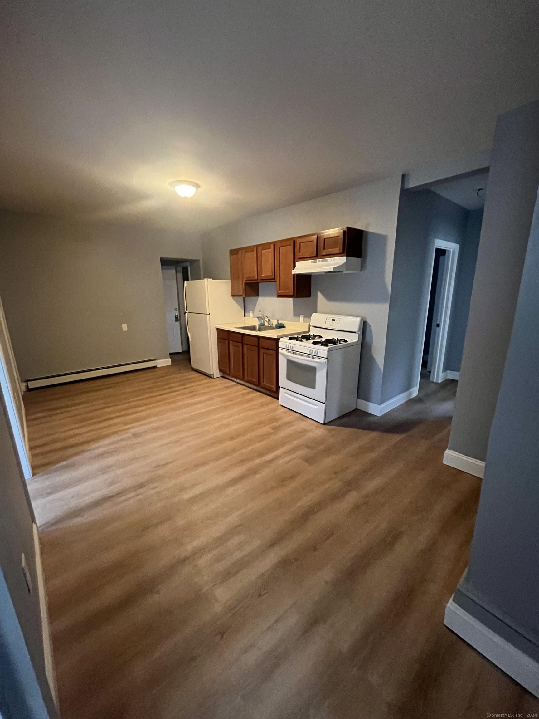 a view of a kitchen with a sink and a refrigerator