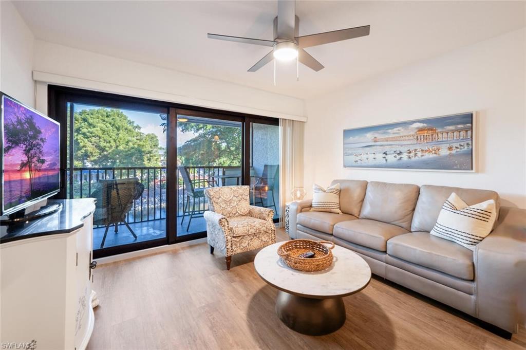 Living room featuring light hardwood / wood-style floors, a healthy amount of sunlight, and ceiling fan