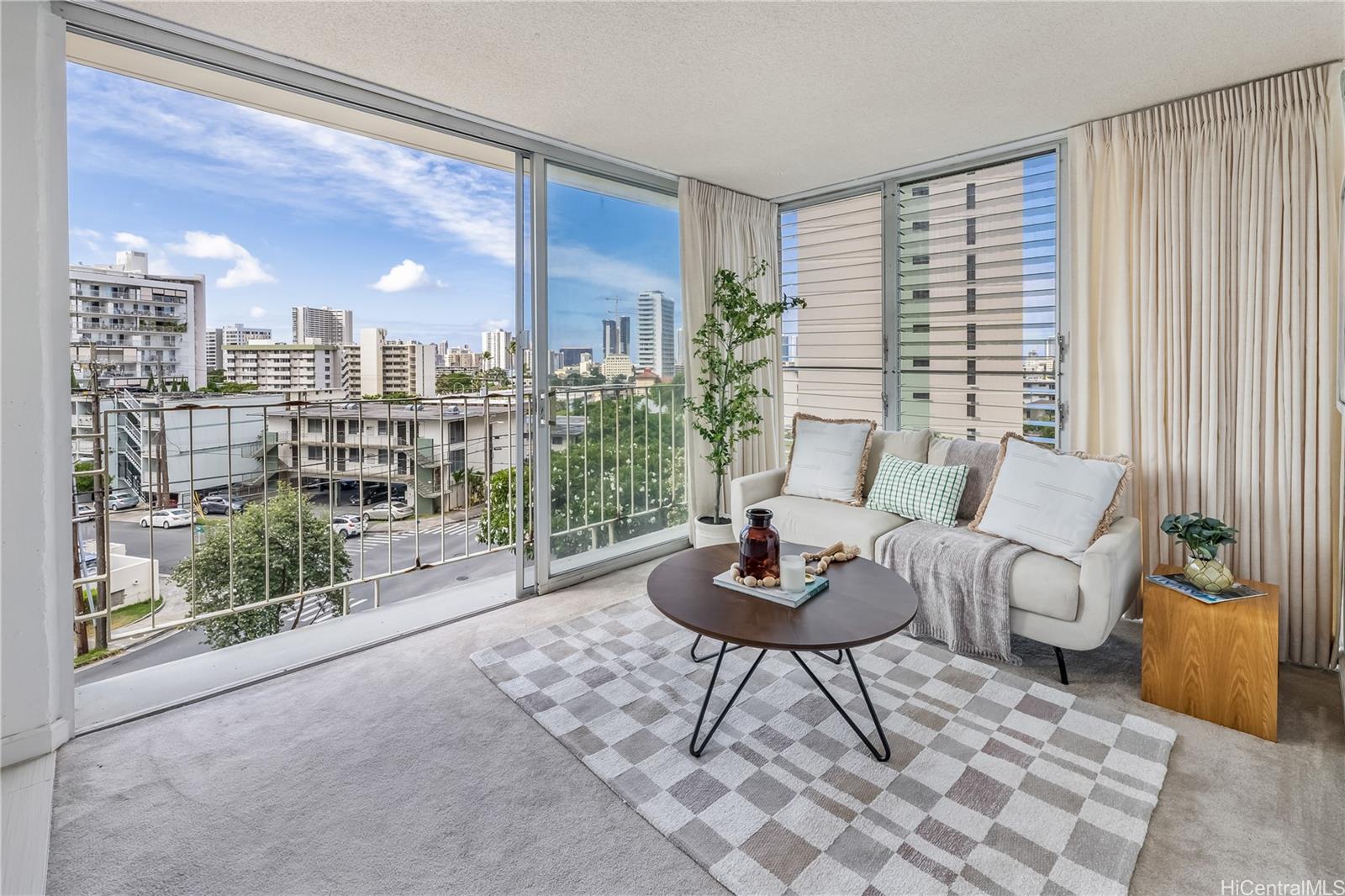 a living room with furniture and a floor to ceiling window