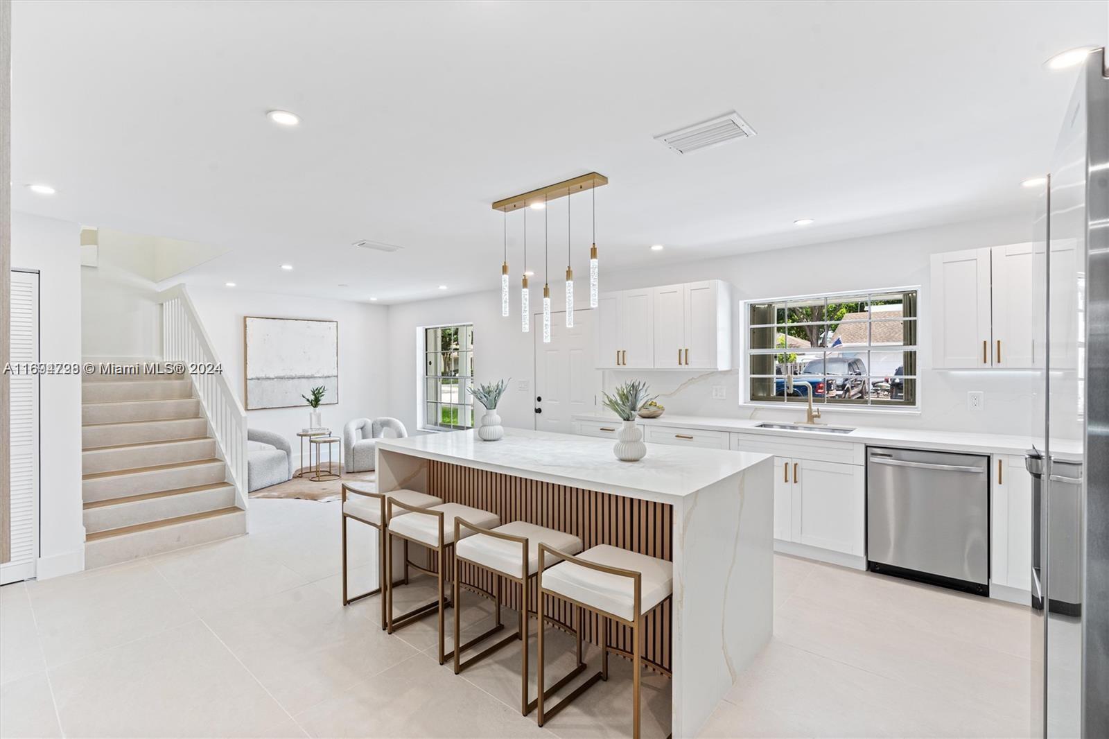 a kitchen with white cabinets and white appliances