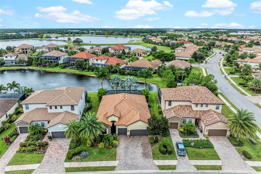 an aerial view of a house with outdoor space and lake view