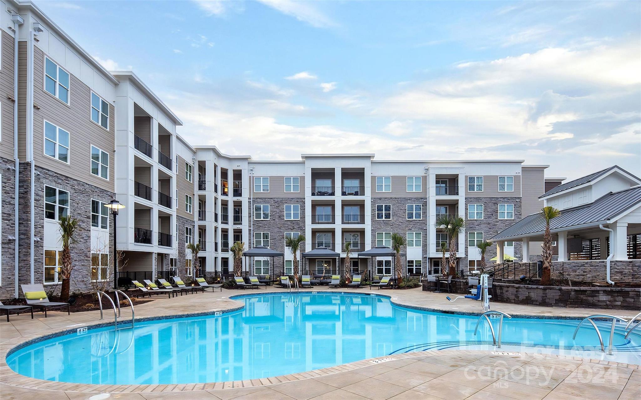 a view of a swimming pool with outdoor seating