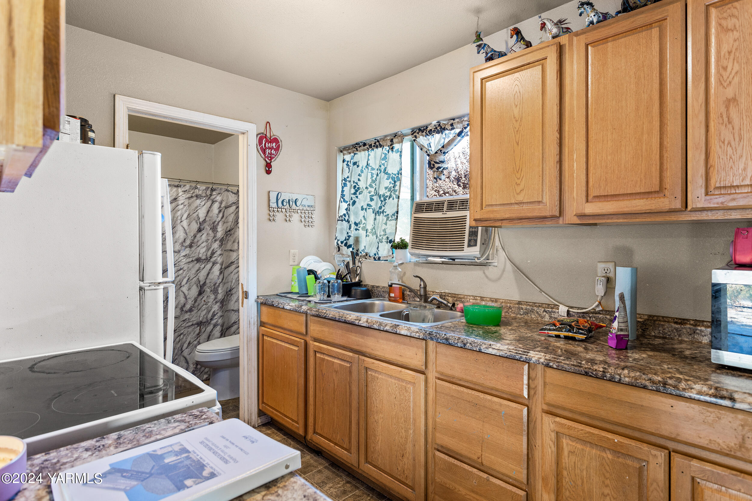 a kitchen with a sink cabinets and window