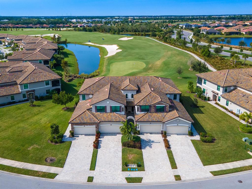 an aerial view of a house with a garden and lake view