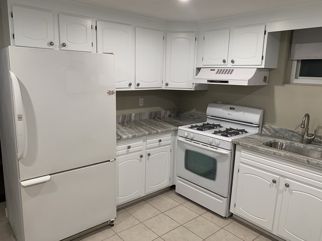 a kitchen with appliances cabinets and a sink