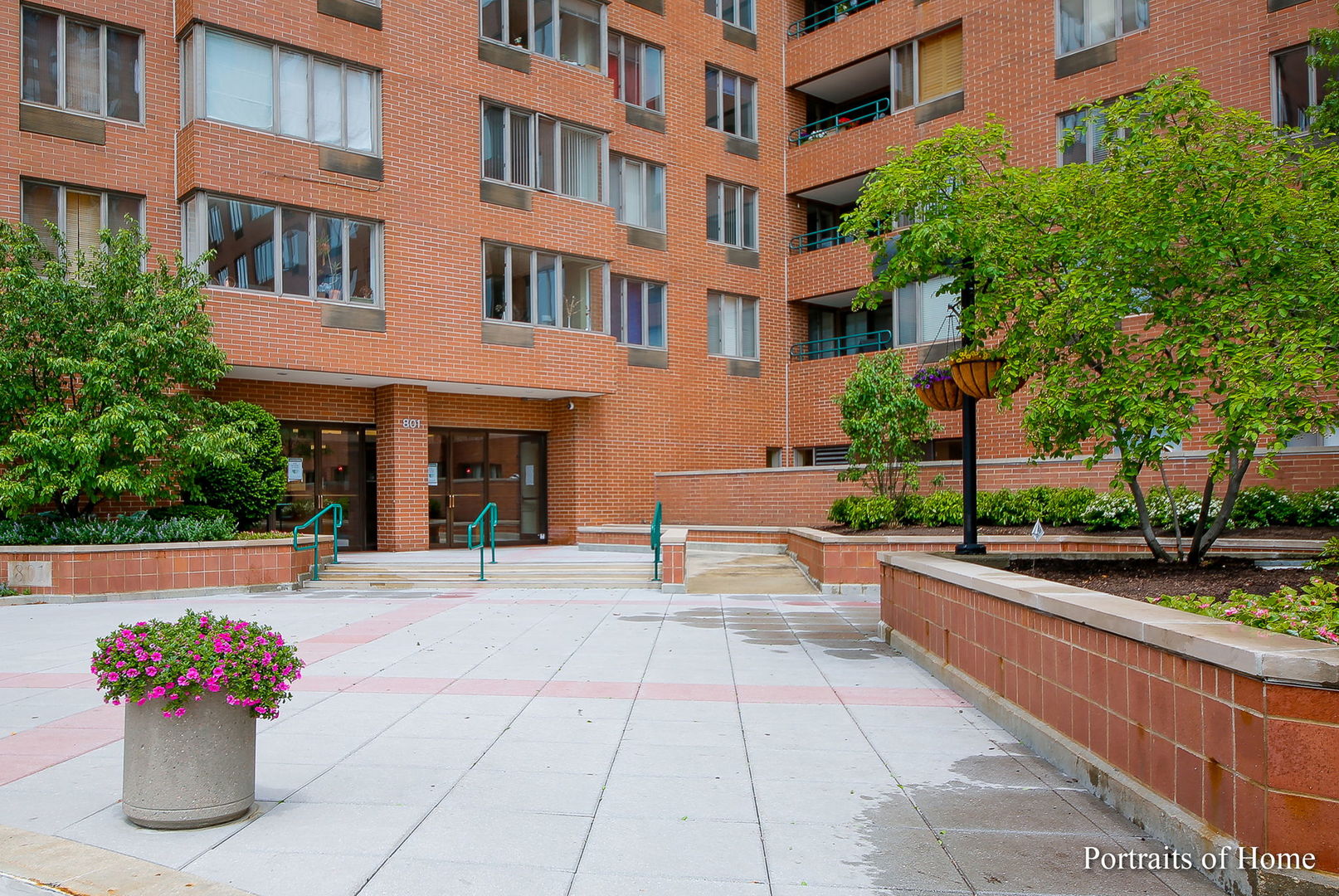 a view of a building with a bench and potted plants