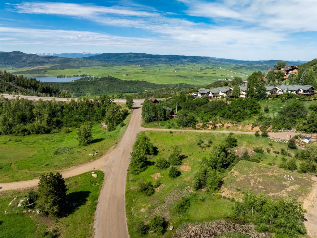 Birds eye view of property with a water and mountain view