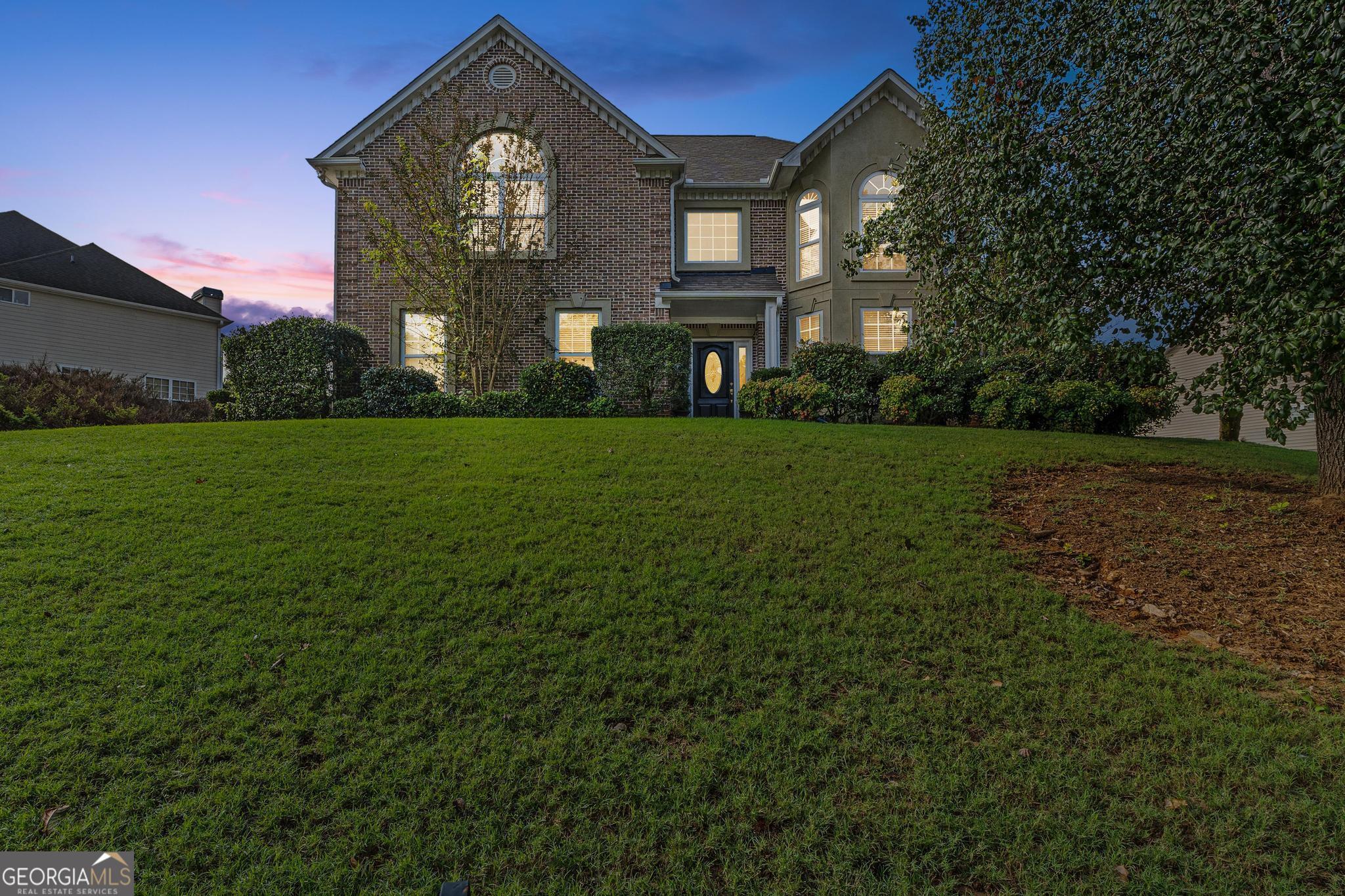 a front view of a house with a big yard