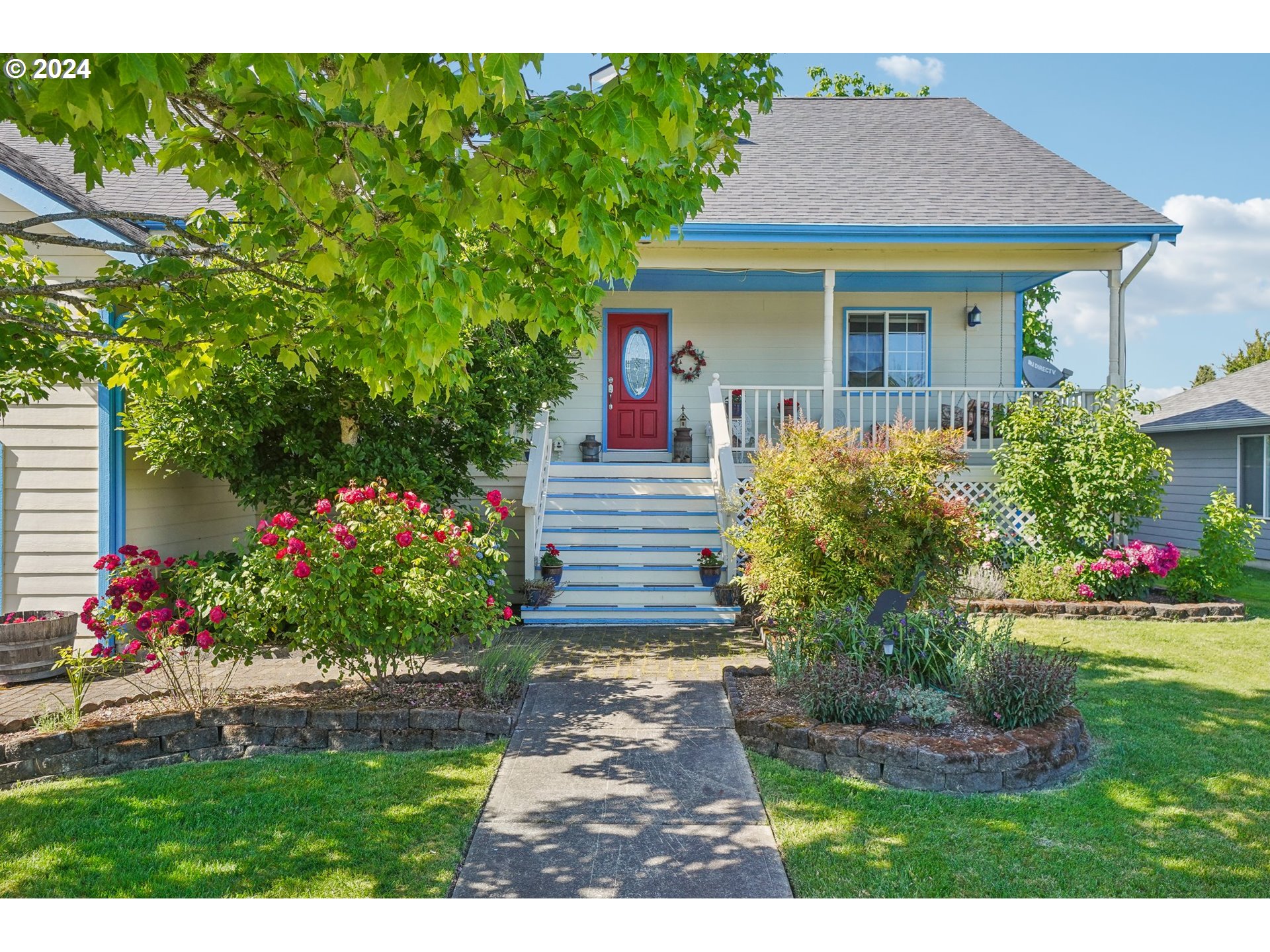 a front view of a house with a garden