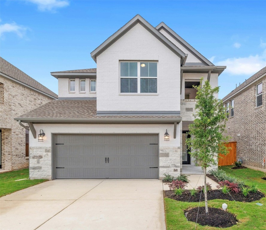 a front view of a house with garage