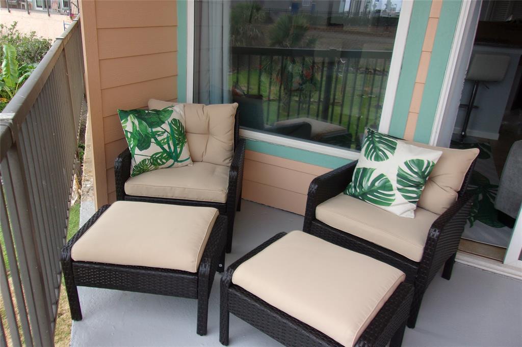 a view of patio with a table and chairs