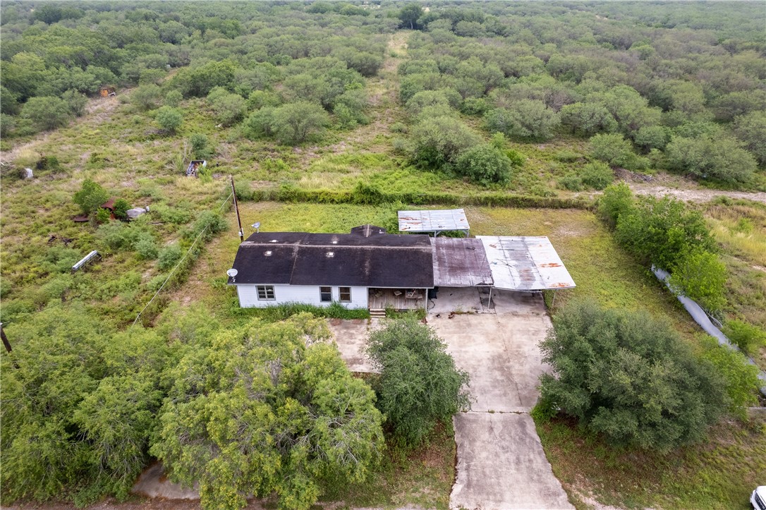 an aerial view of a house with a yard and lake view