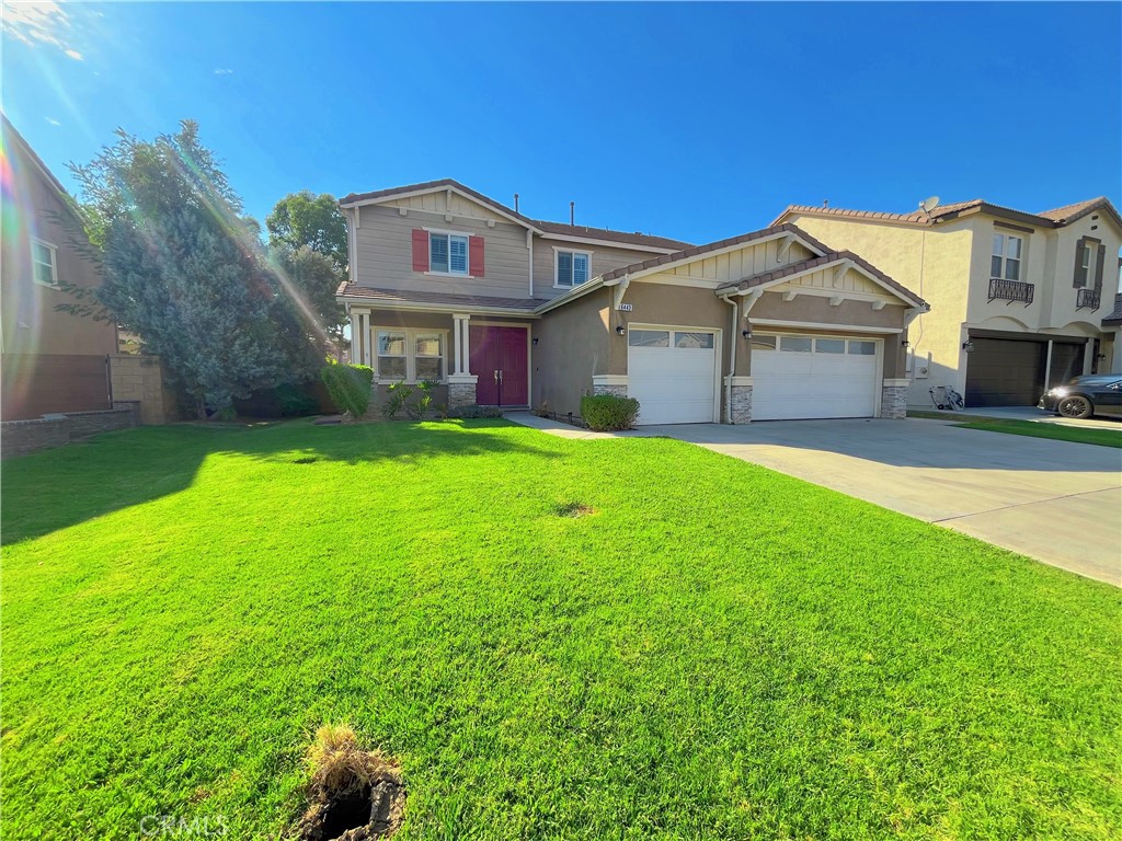 a view of a house with a big yard plants and large trees