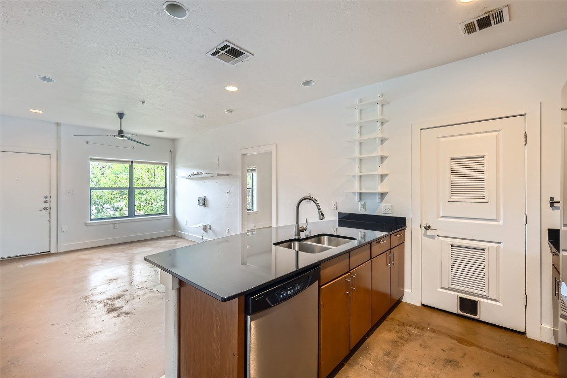 a kitchen that has a sink a stove and a window