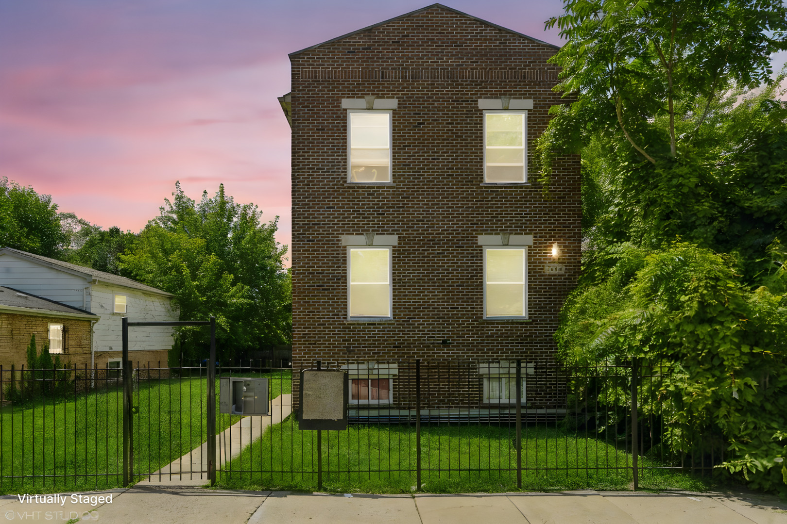 a view of a brick building next to a yard