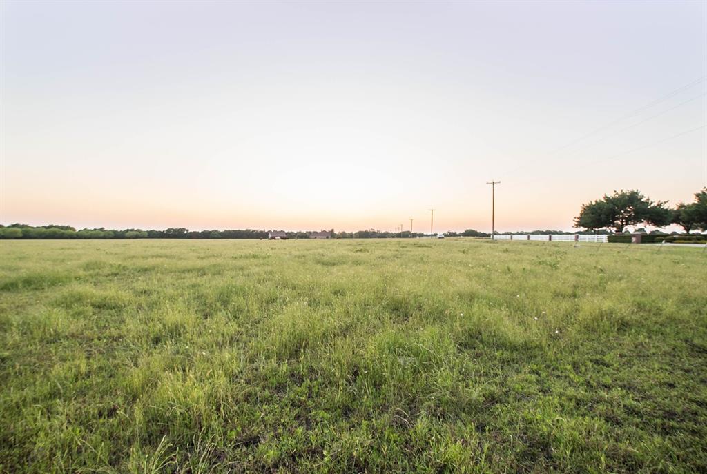 a view of a field with an ocean view