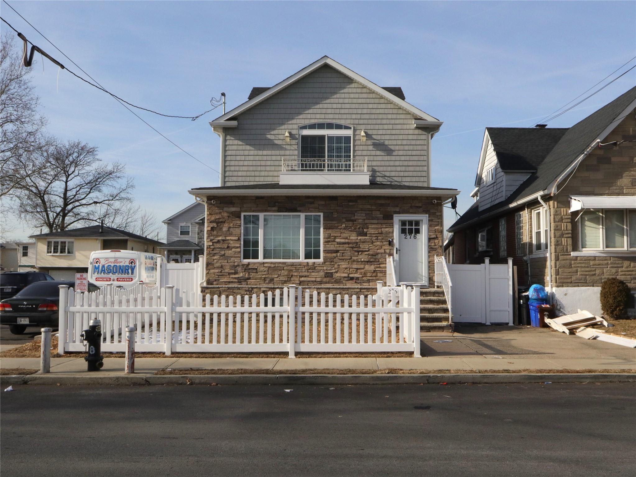 a front view of a house with a road