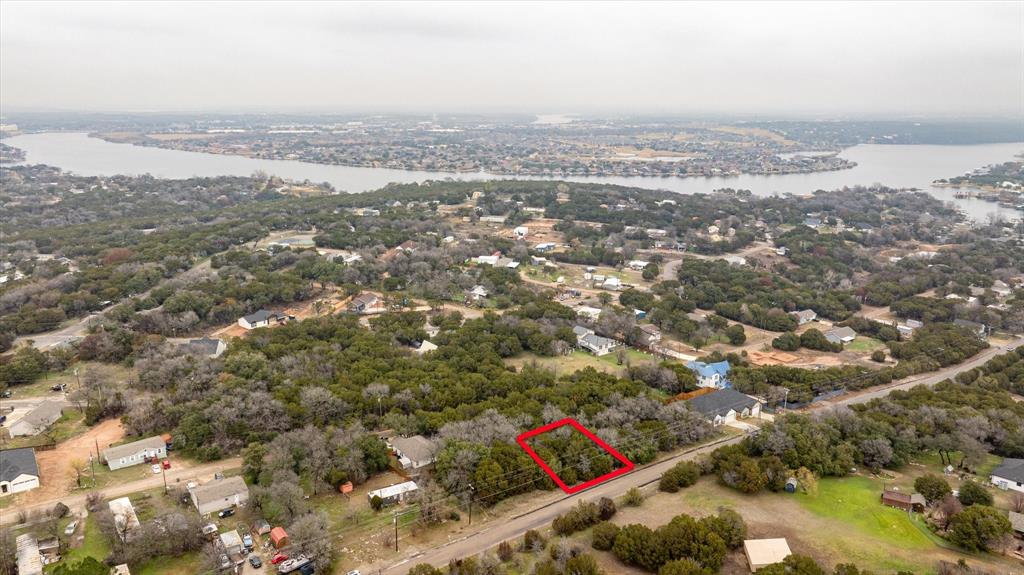 an aerial view of house with yard and mountain view in back