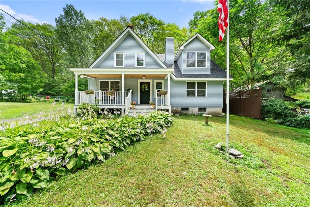 View of front of home featuring a front yard and a porch