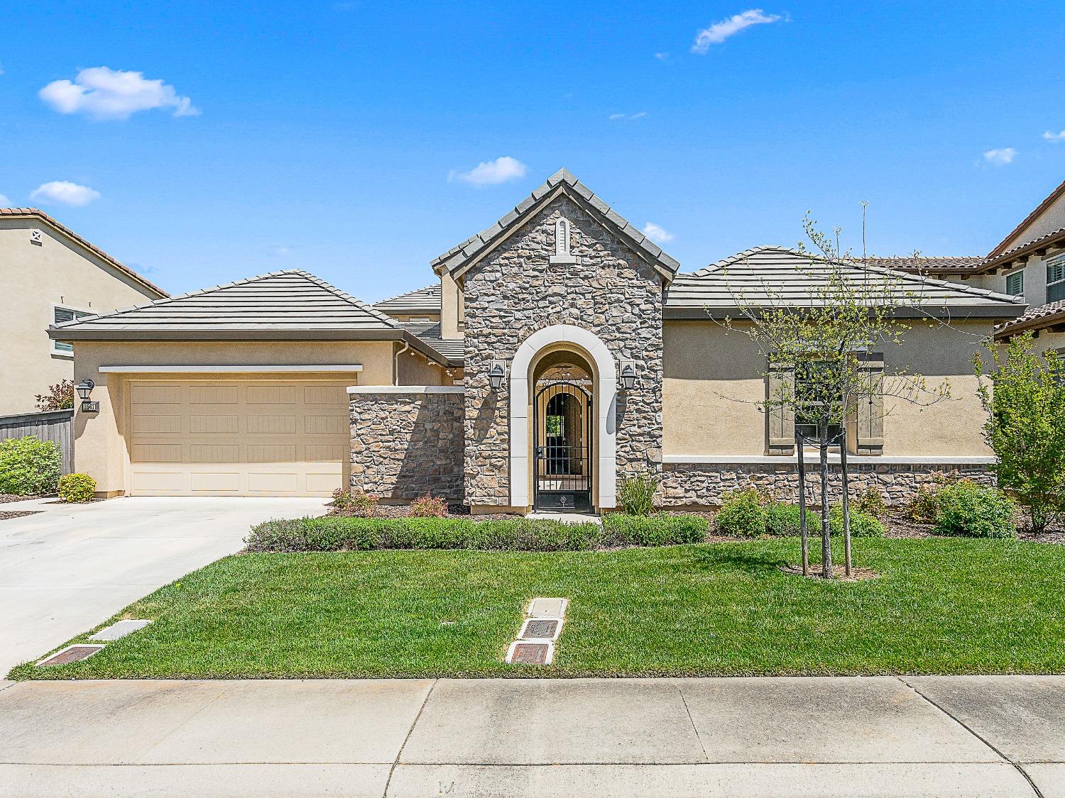 a front view of a house with a yard and garage