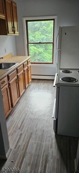 a view of a room with wooden floor and a window