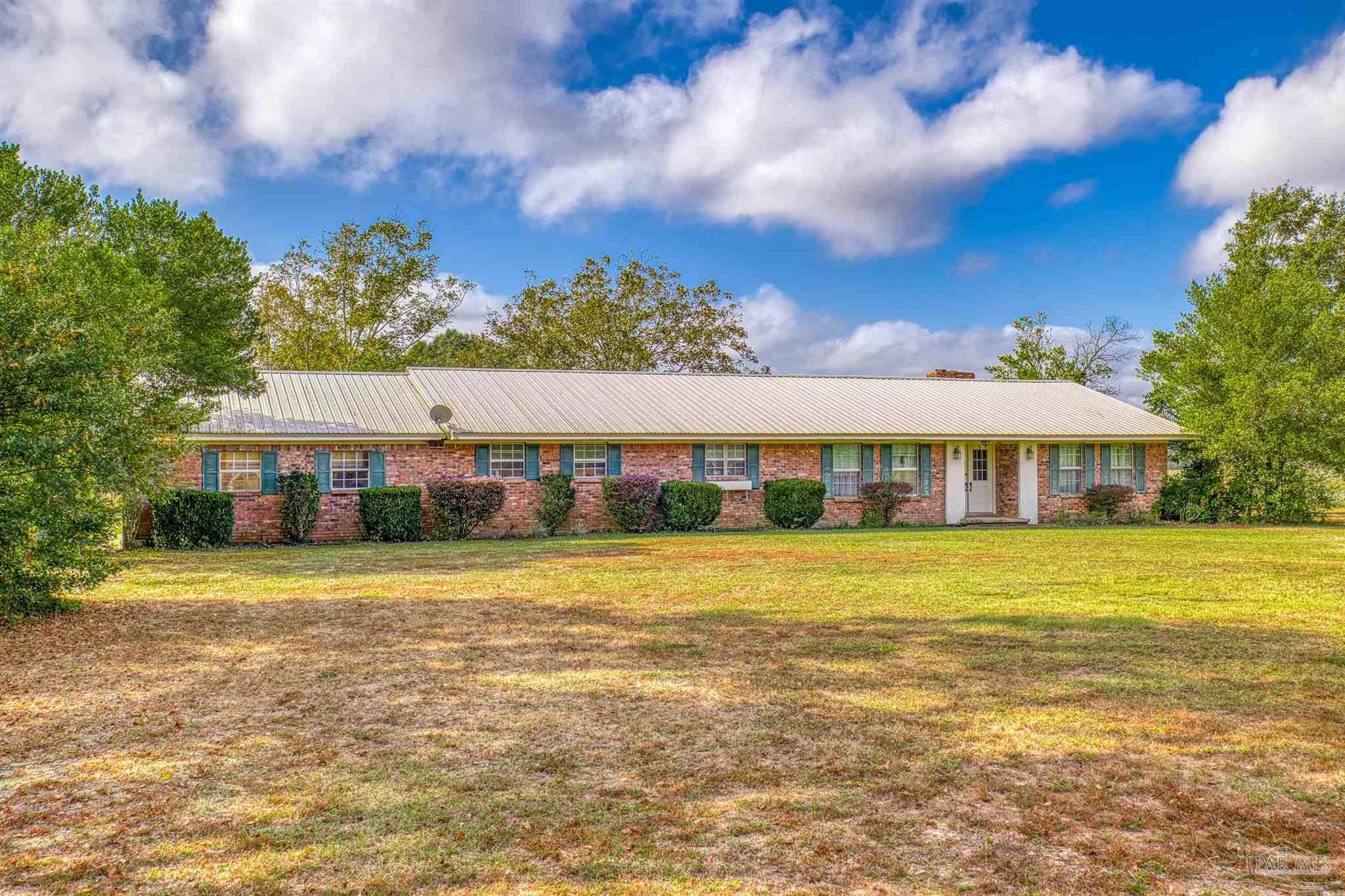 a front view of a house with a big yard