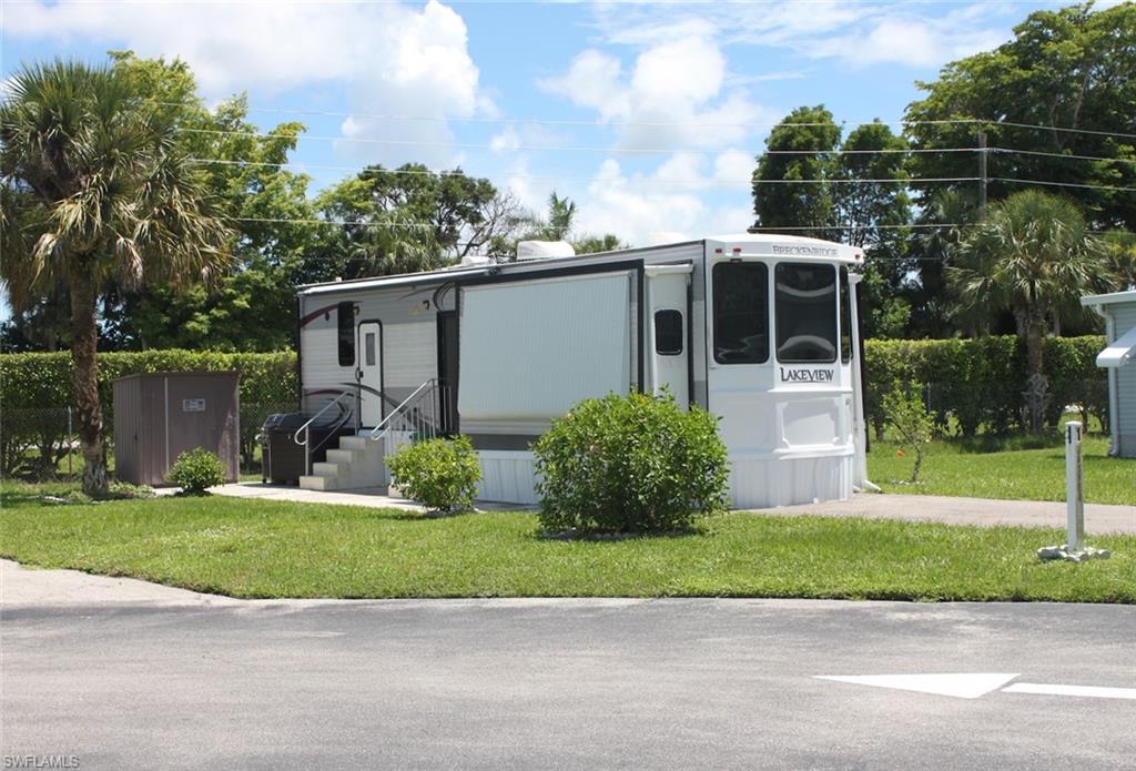 a front view of a house with a yard and a garage