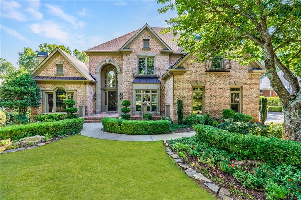 a front view of a house with garden