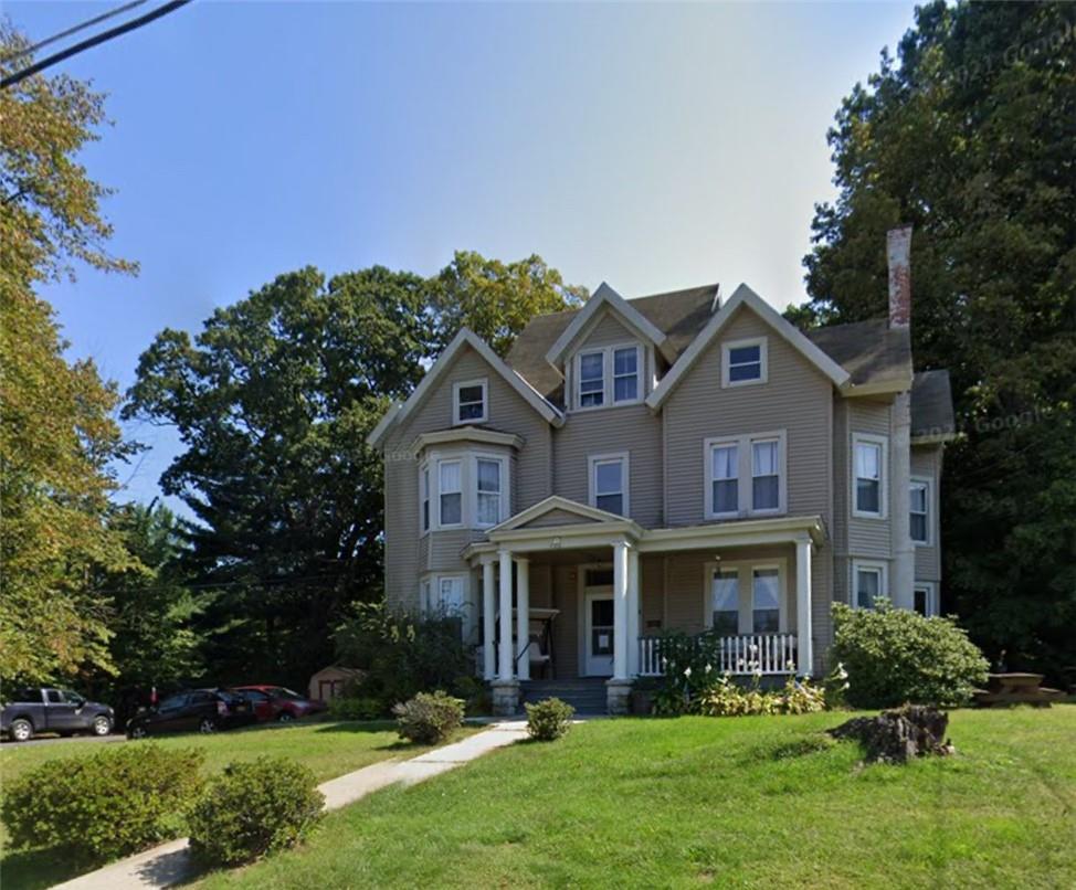 View of front of house featuring a front yard and covered porch