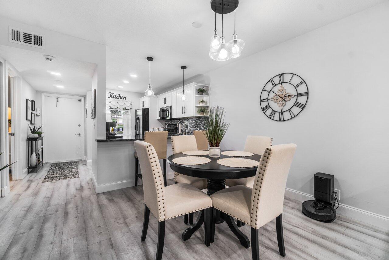 a view of a dining room with furniture and wooden floor