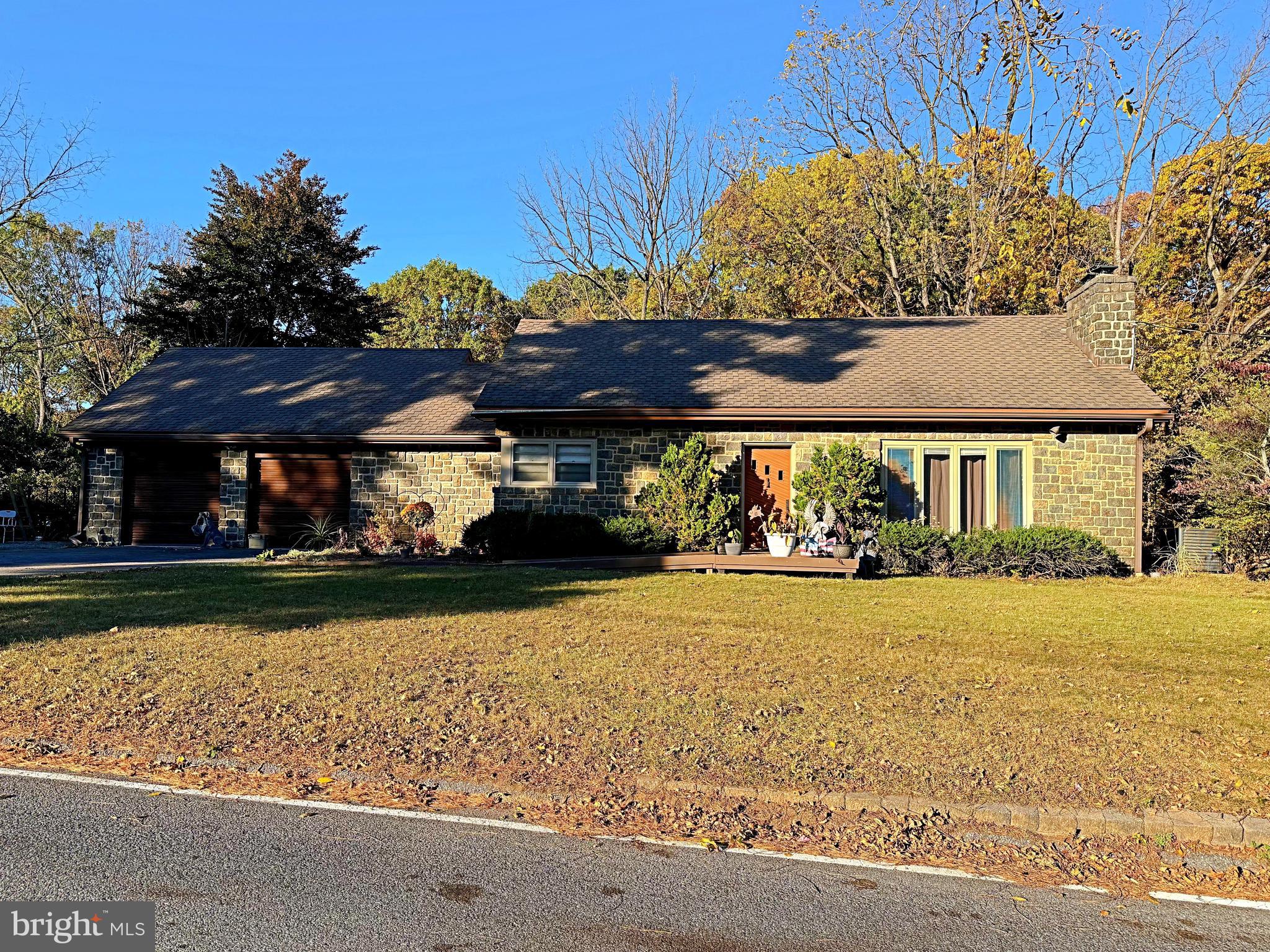 a front view of house with yard and green space