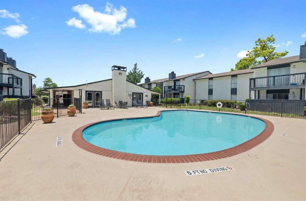 a swimming pool with outdoor seating and yard