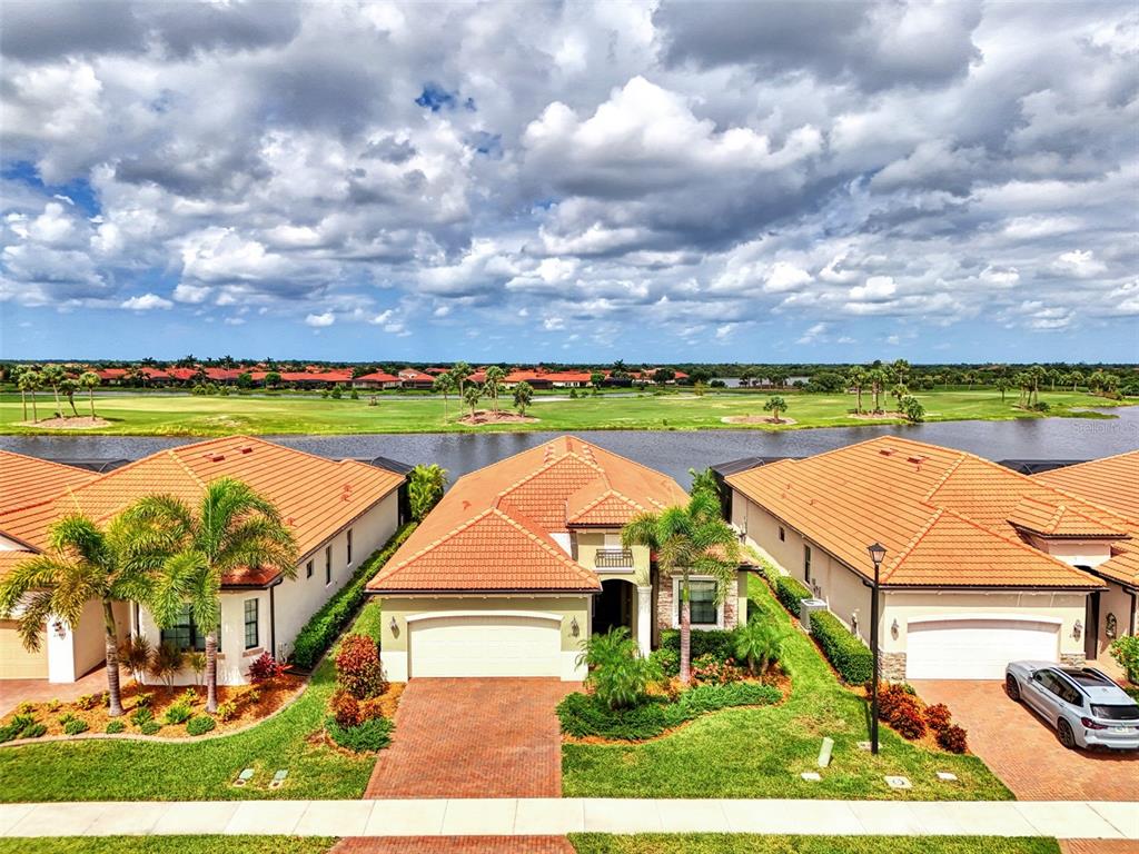 an aerial view of residential houses with outdoor space and swimming pool