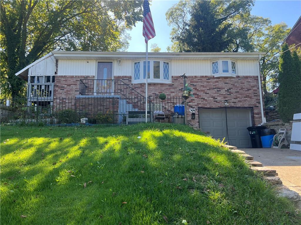 a view of house with backyard and a patio