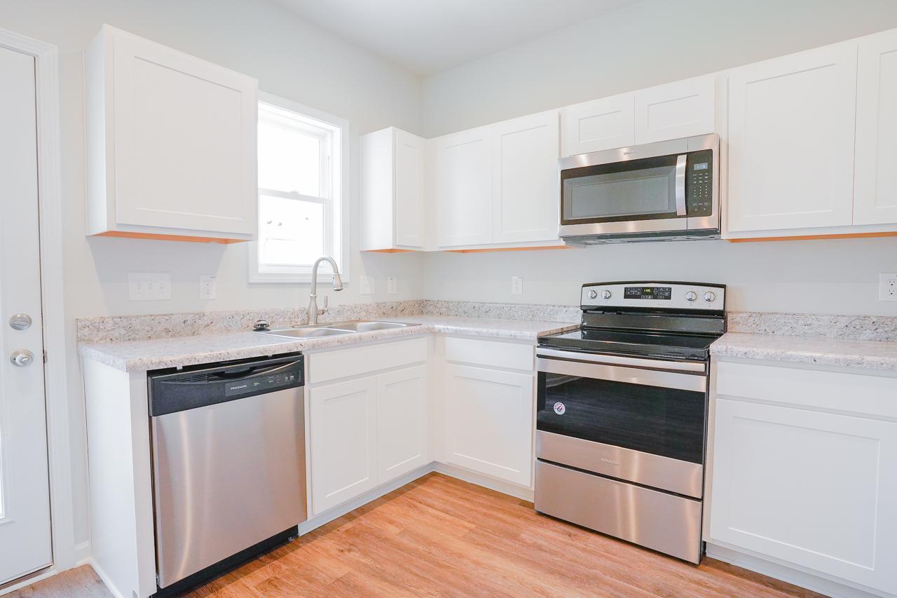 a kitchen with a stove and a microwave