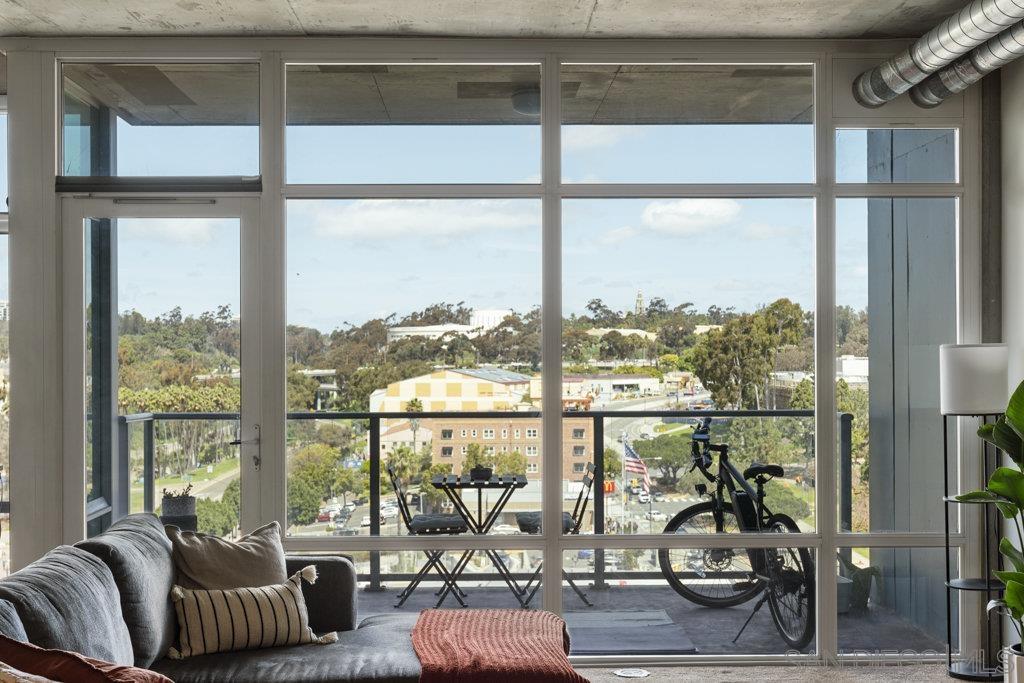 a living room with furniture and floor to ceiling windows