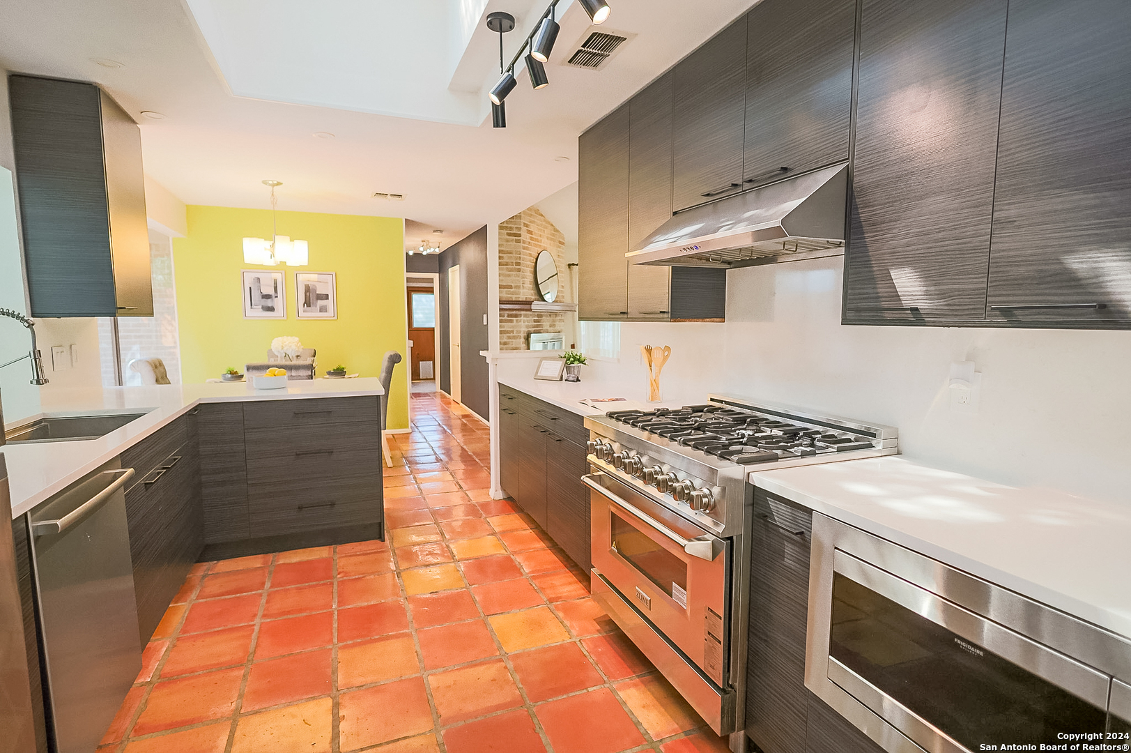 a kitchen with stainless steel appliances granite countertop a stove and a sink