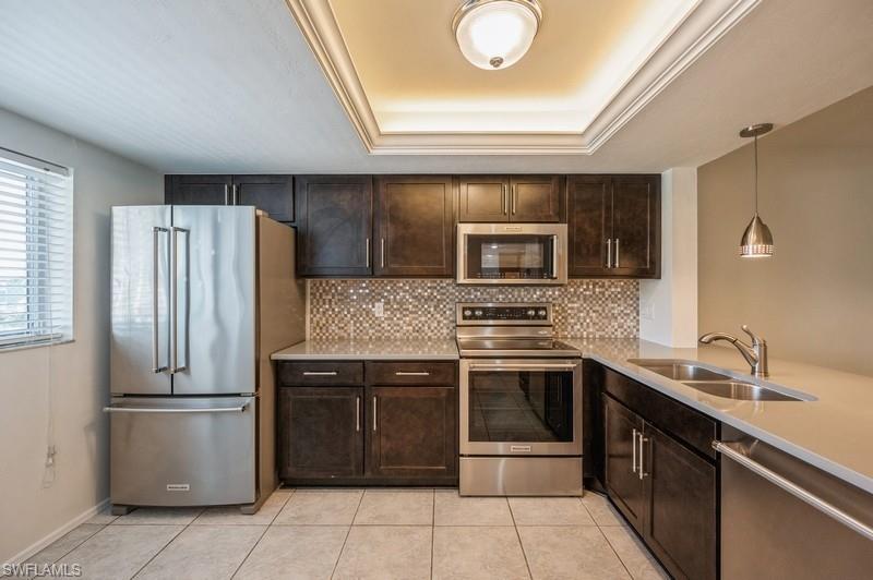 a kitchen with a sink and stainless steel appliances