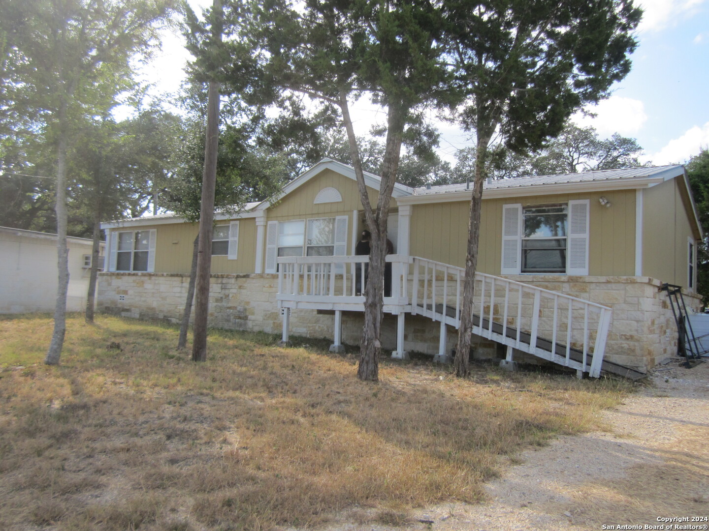 a view of a house with a backyard and a tree