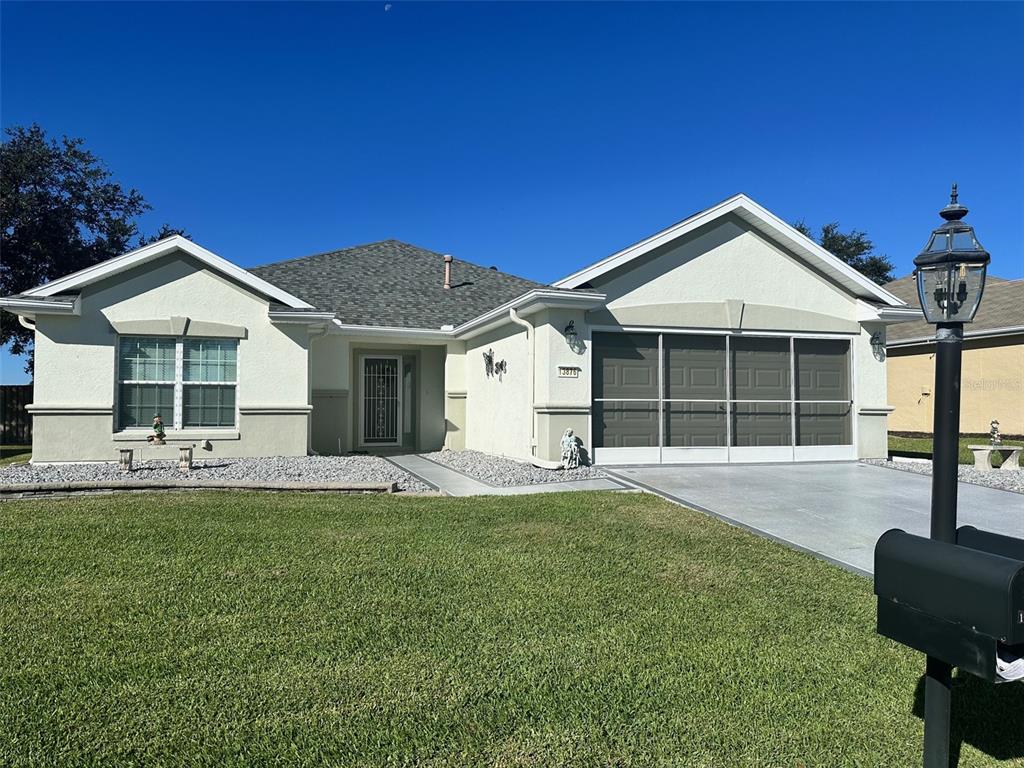 a front view of a house with a yard and garage