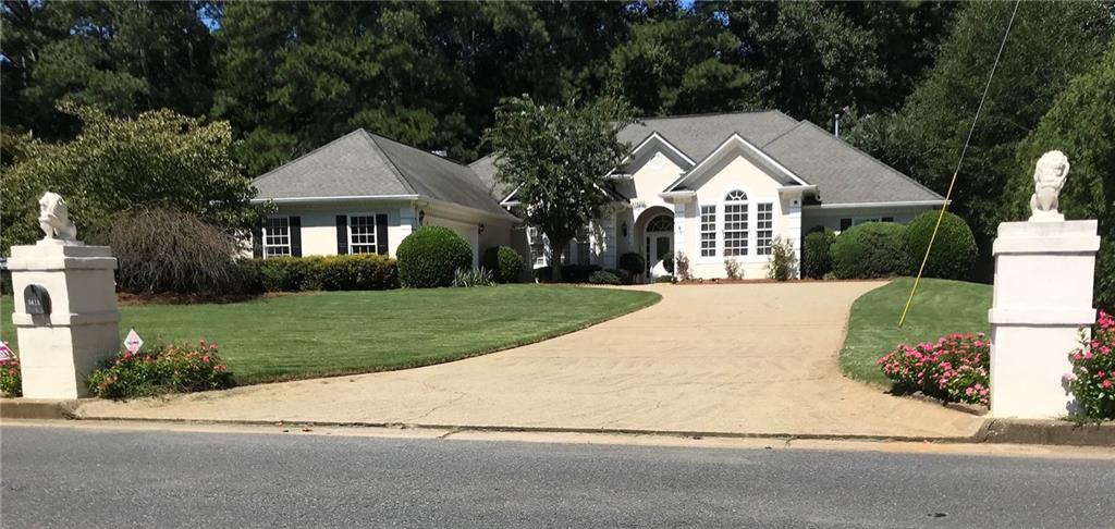 a view of house with yard and green space