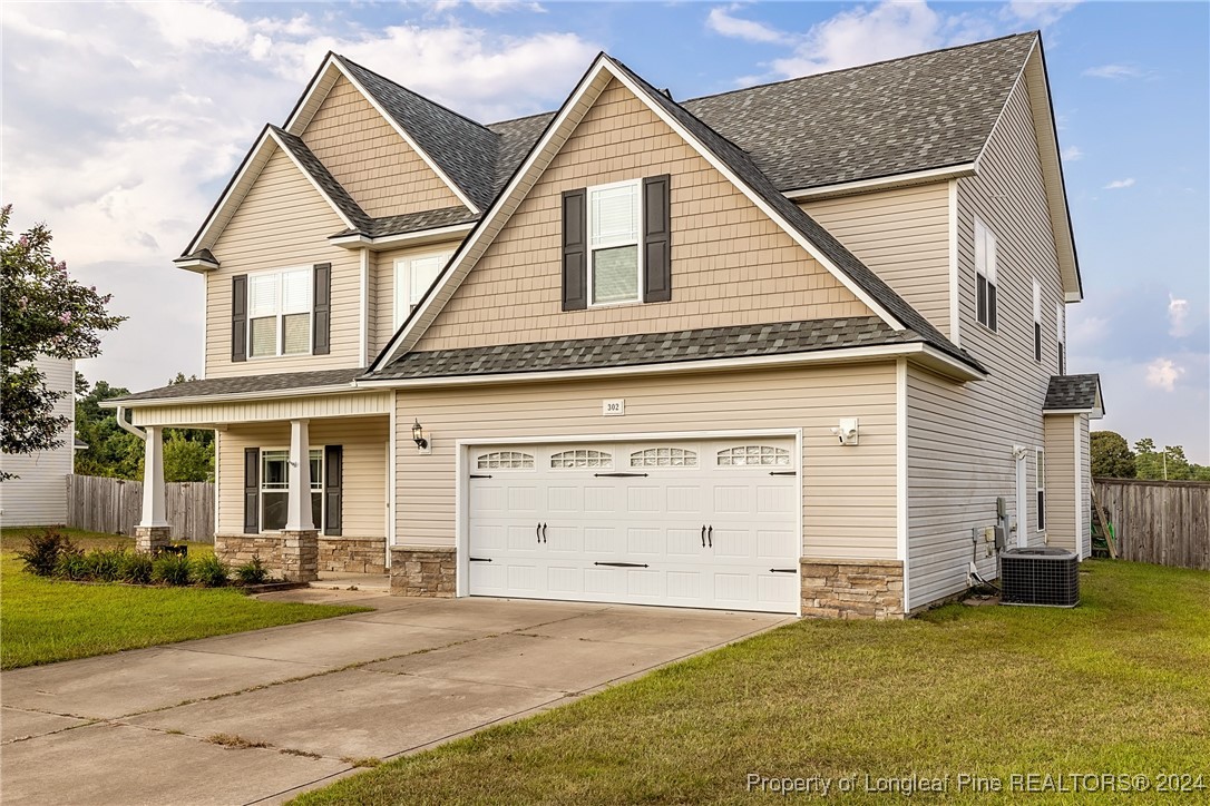 a view of a house with a yard and garage