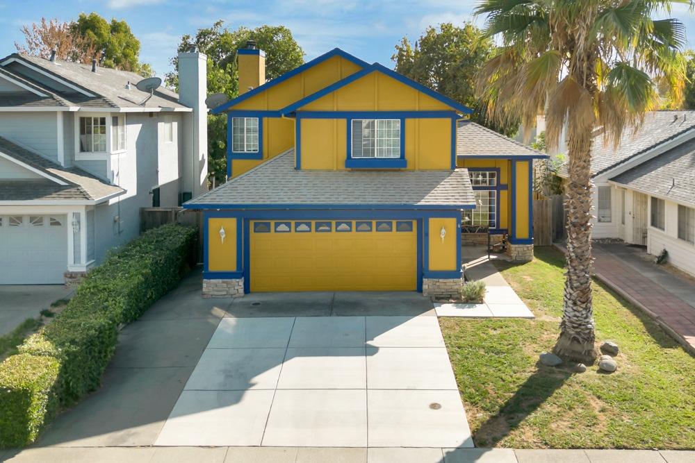 a front view of a house with a yard garage and outdoor seating